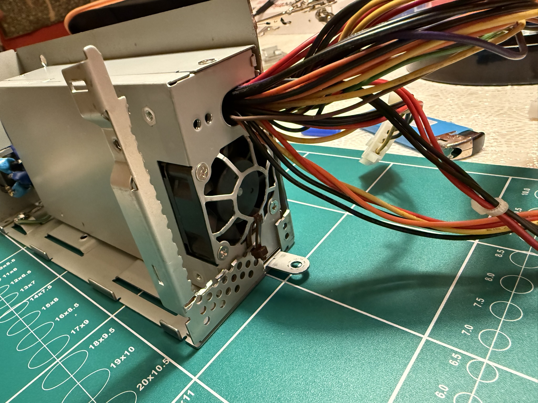PSU mounted in the bracket with cable ties(!)