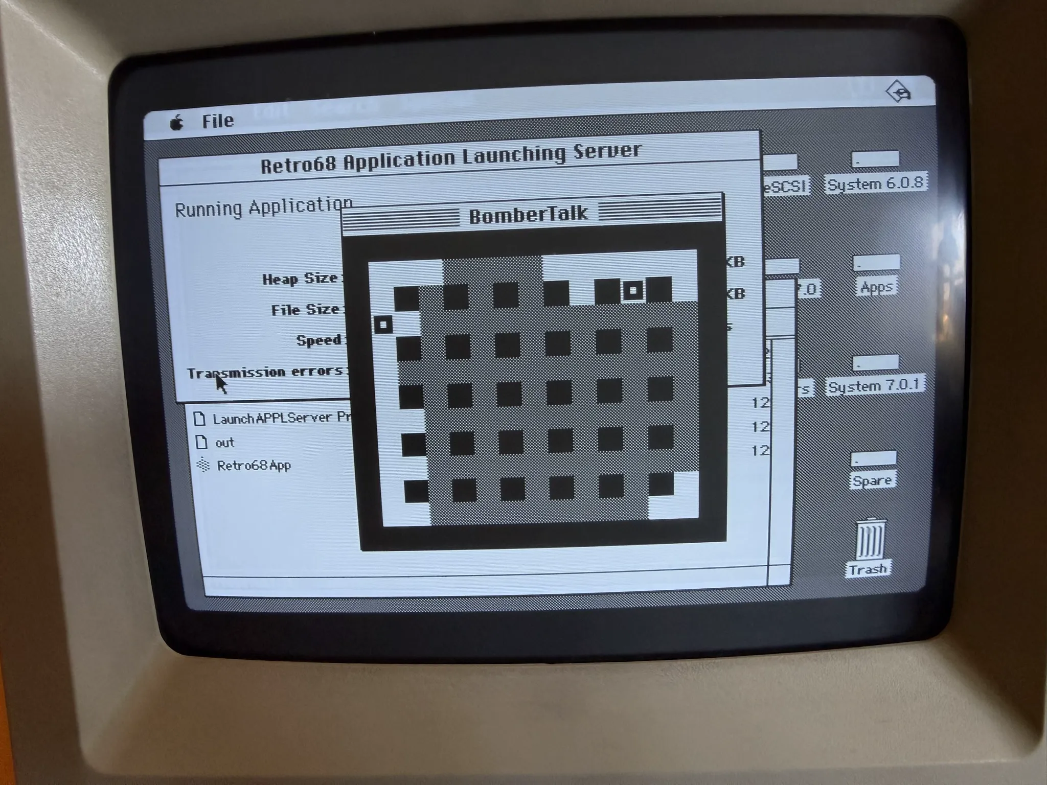 Mac SE running BomberTalk showing monochrome game grid with two player blocks