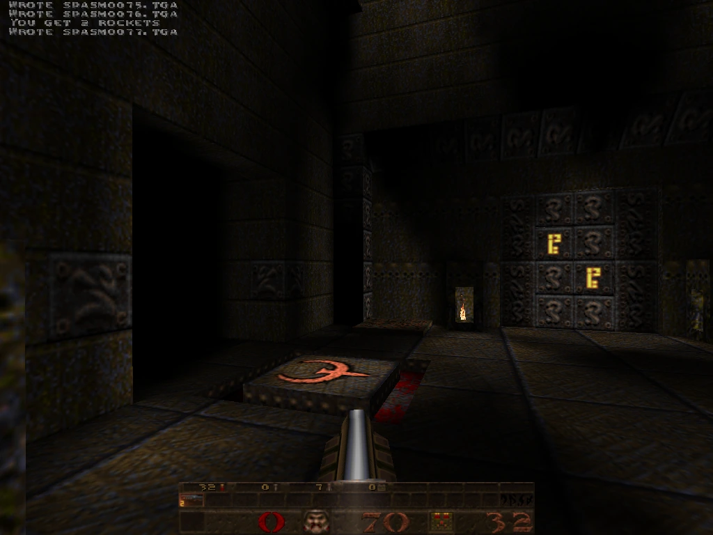 quicksilver — slipgate area with the Q-rune floor logo, glowing E sigils and a distant torch