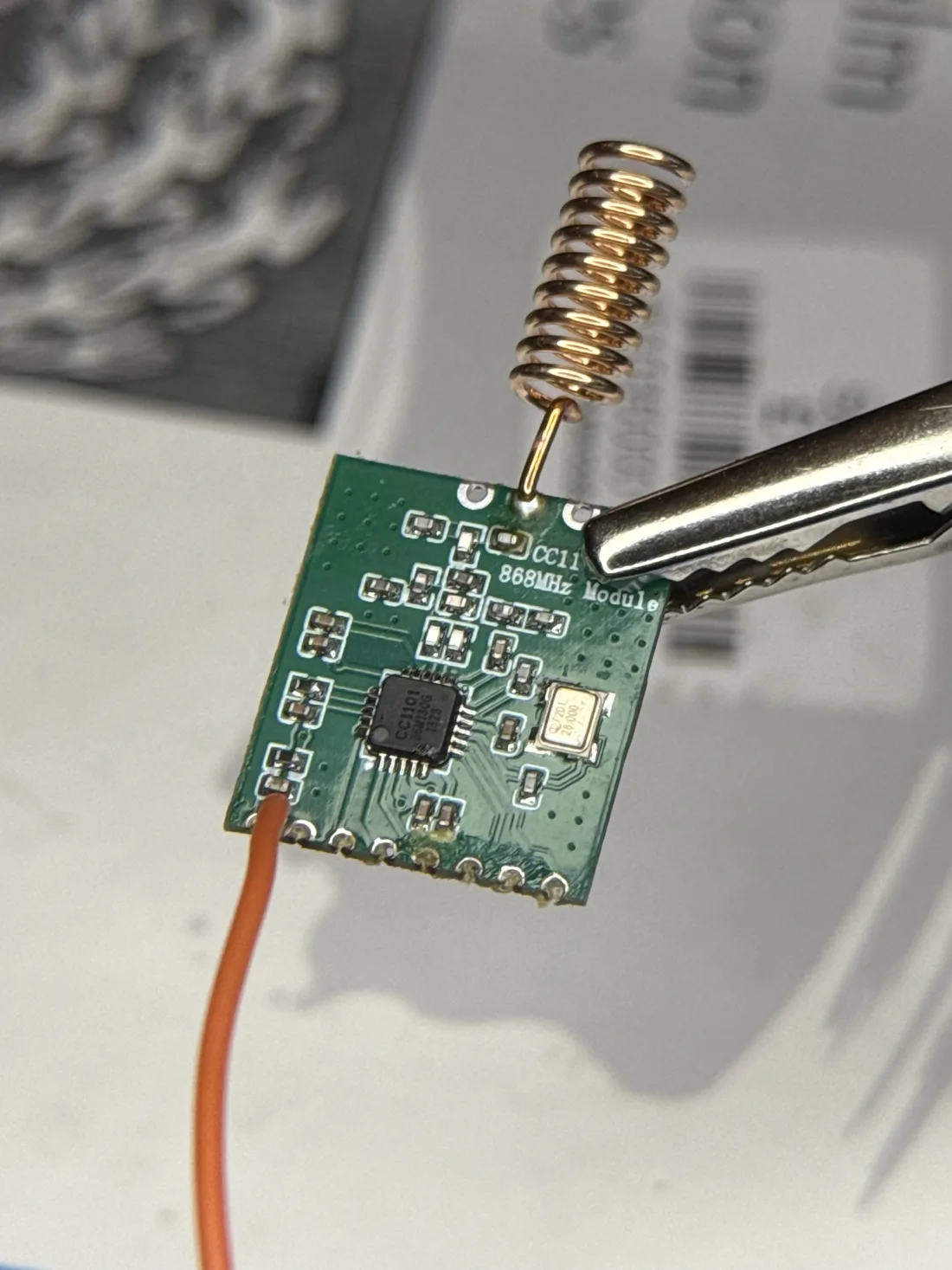 The CC1101 radio module with a spring antenna soldered on