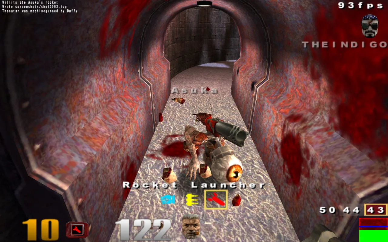 Quake III on an iMac G5 — a blood-splattered corridor with a rocket launcher pickup and a dropped weapon